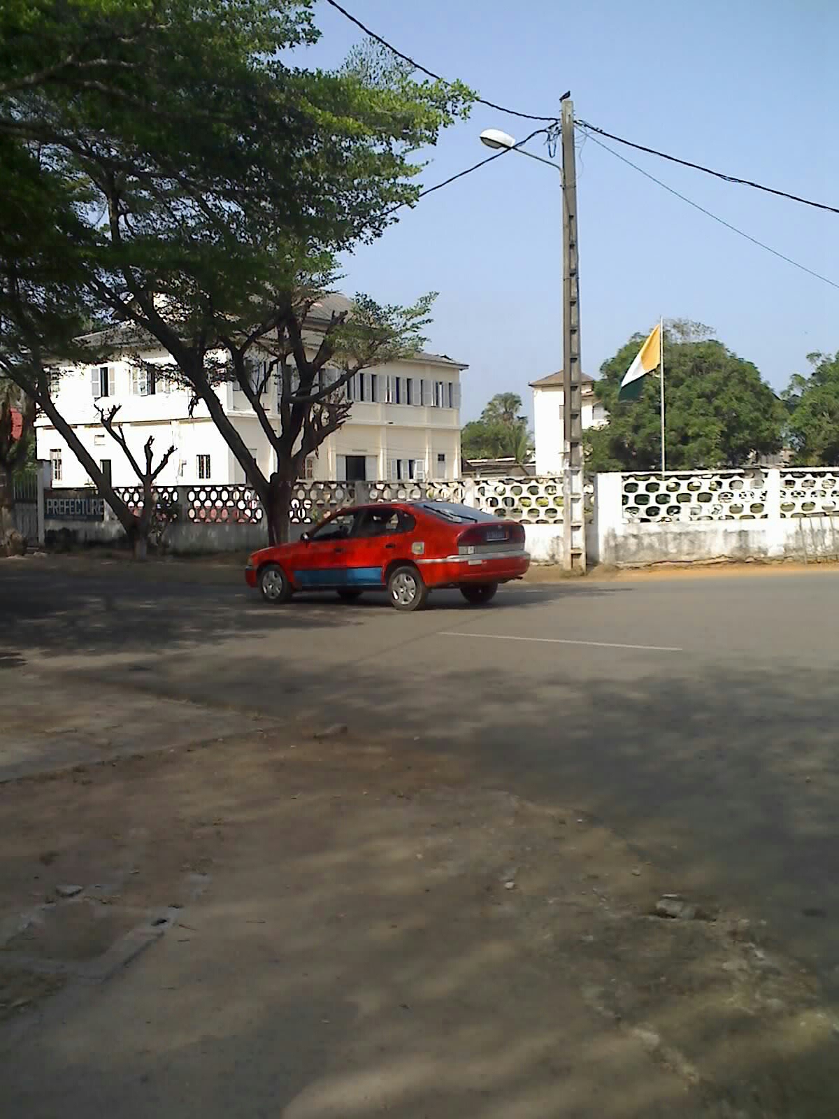 Typisches ivoirisches Taxi vor einem Regierungsgebäude